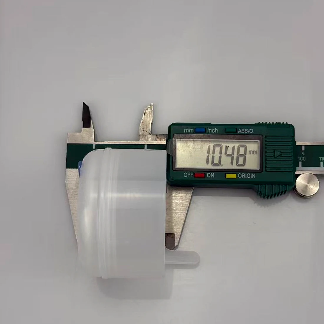 Digital caliper measuring the neck diameter of a moulded closure