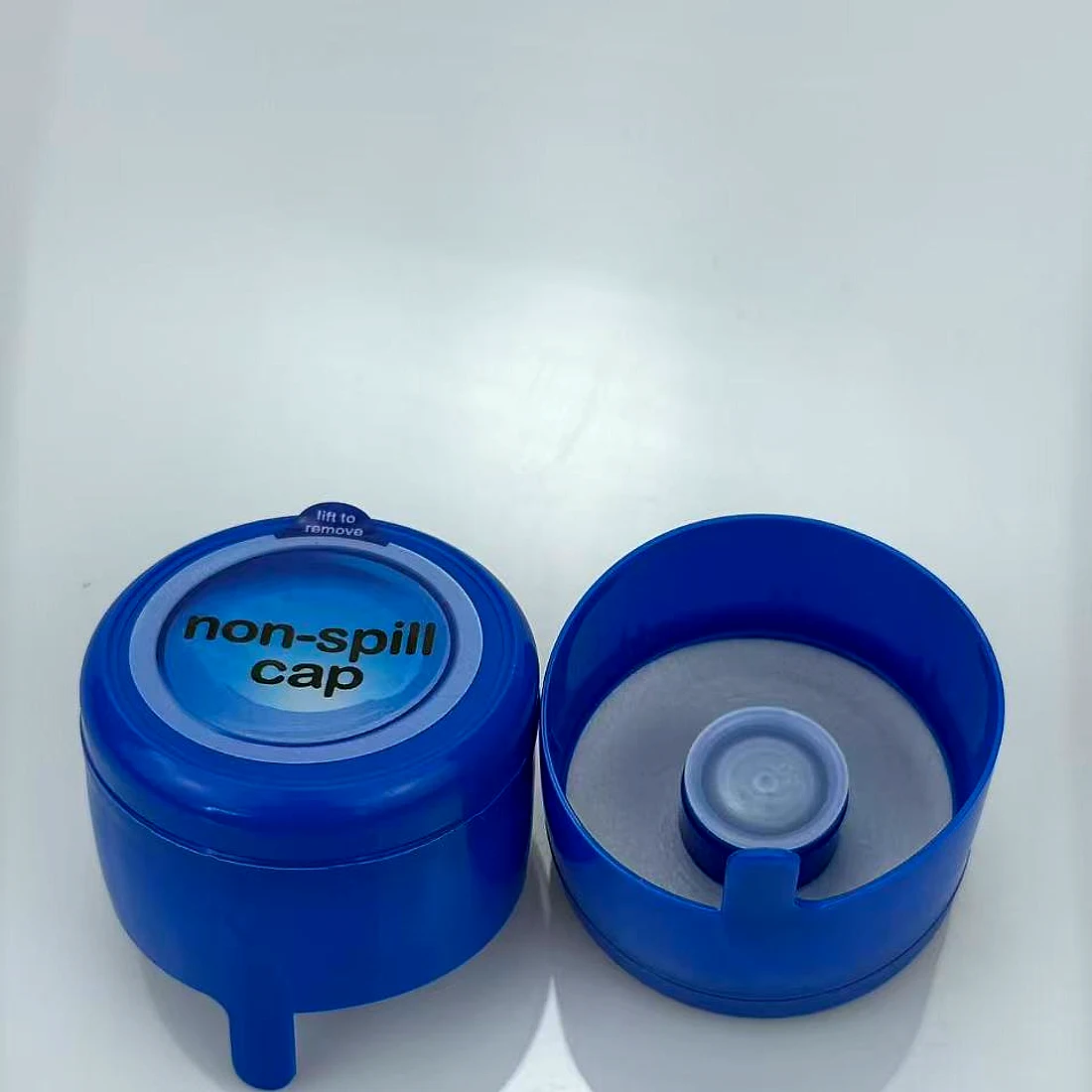 Blue non-spill cap shown open and closed